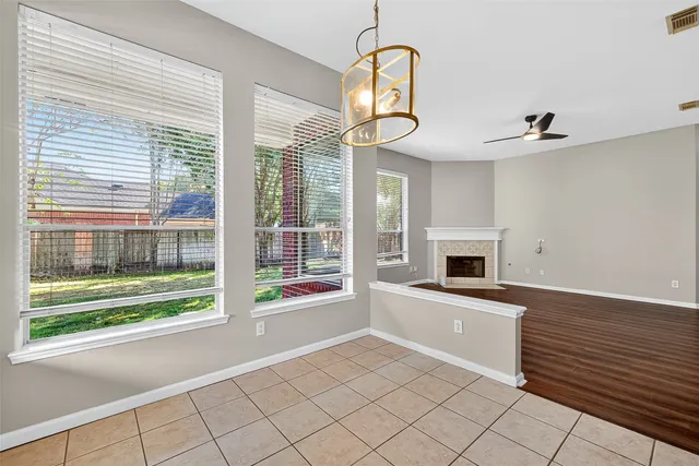 a view of a kitchen with a sink dishwasher and a fireplace