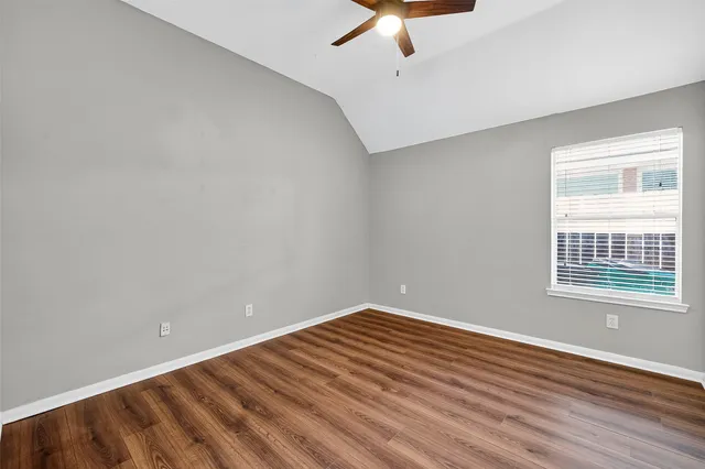 an empty room with closet and chandelier fan