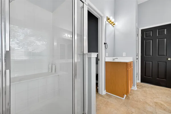a bathroom with a tub sink and mirror