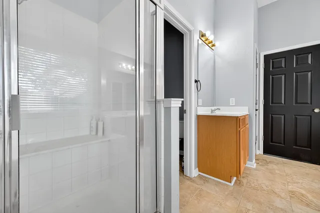 a bathroom with a tub sink and mirror