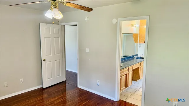 a view of a room with wooden floor