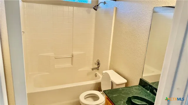 a front view of a house with a yard outdoor seating and garage