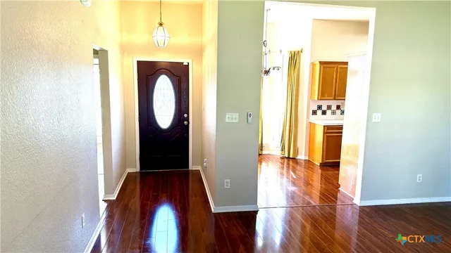 a view of hallway with wooden floor