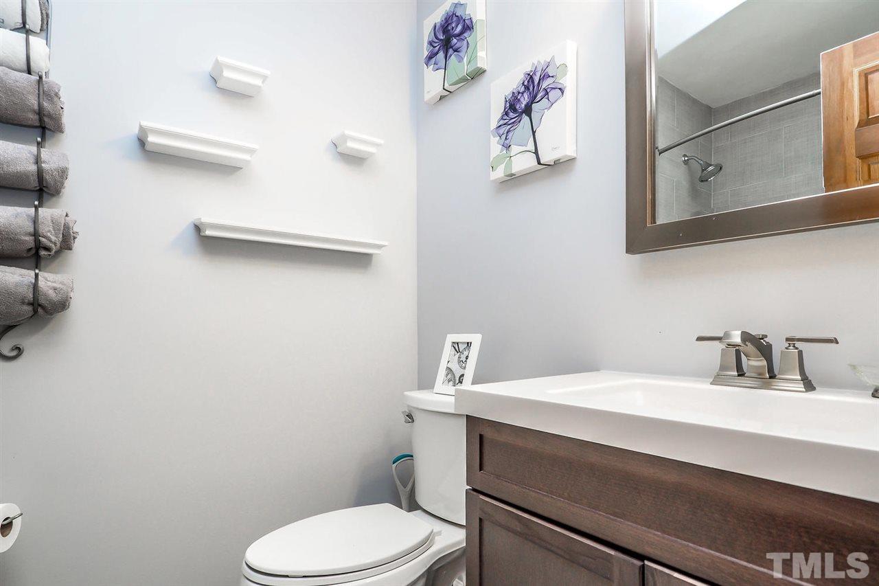 3953 Haithcock Road Raleigh, NC 27604 - Photo 11 of 25 a bathroom with a sink mirror and toilet