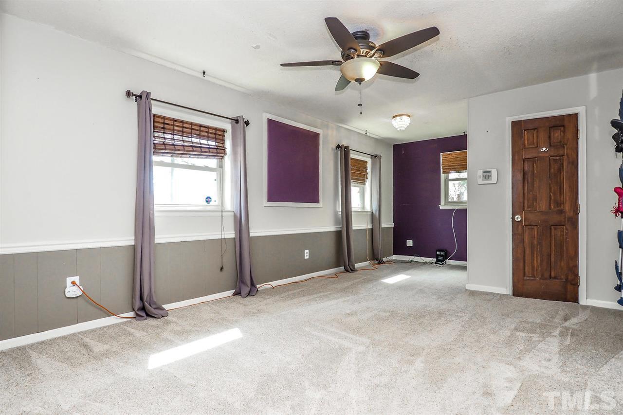 3953 Haithcock Road Raleigh, NC 27604 - Photo 13 of 25 a view of an empty room with a ceiling fan