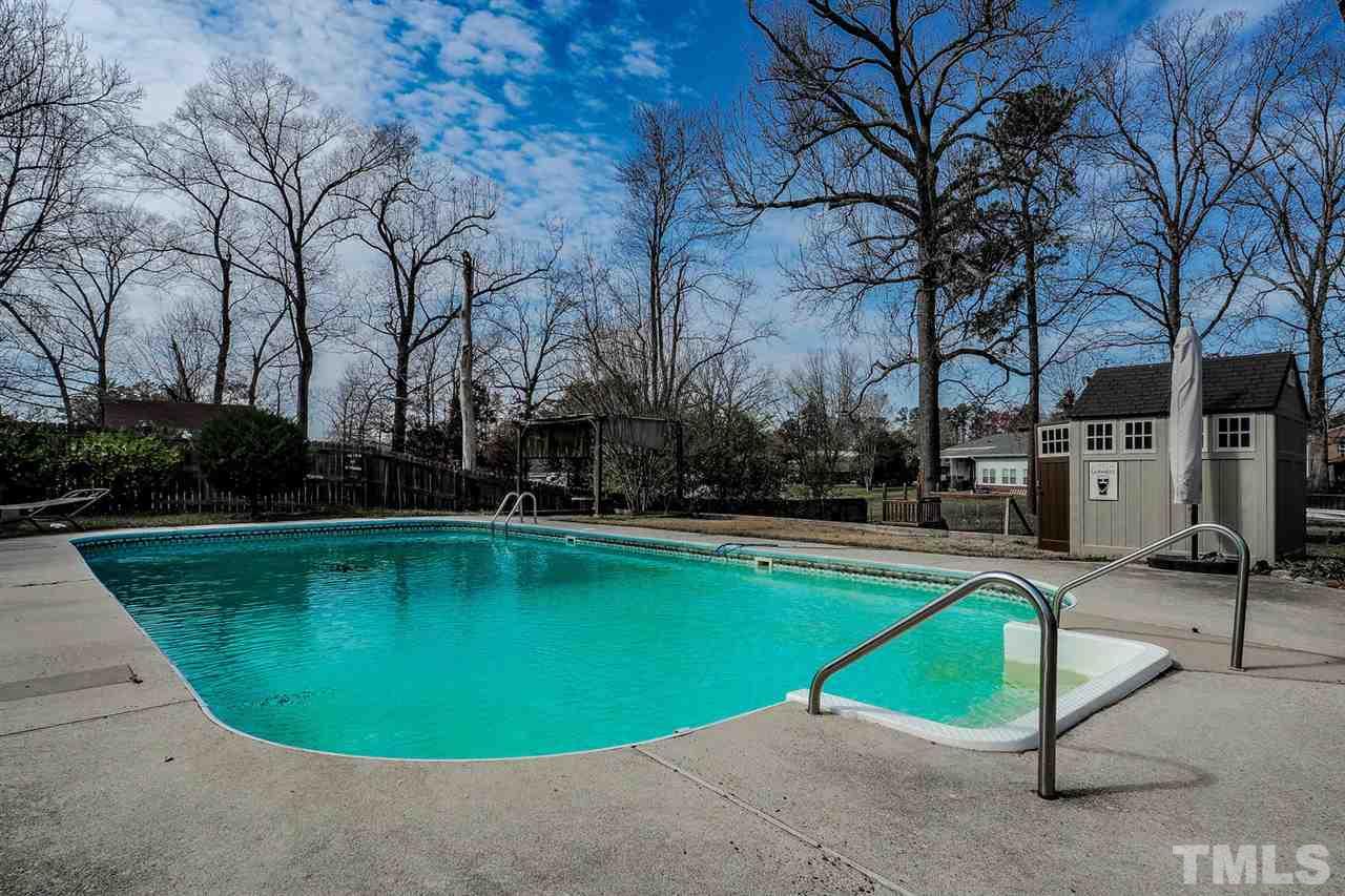 3953 Haithcock Road Raleigh, NC 27604 - Photo 19 of 25 a view of a swimming pool with a yard
