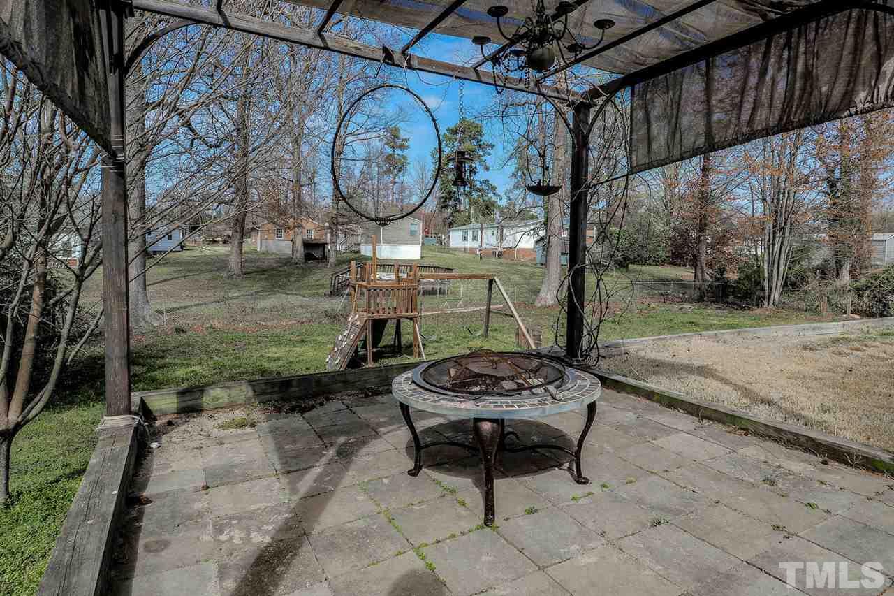3953 Haithcock Road Raleigh, NC 27604 - Photo 20 of 25 a wooden bench with a table and chairs