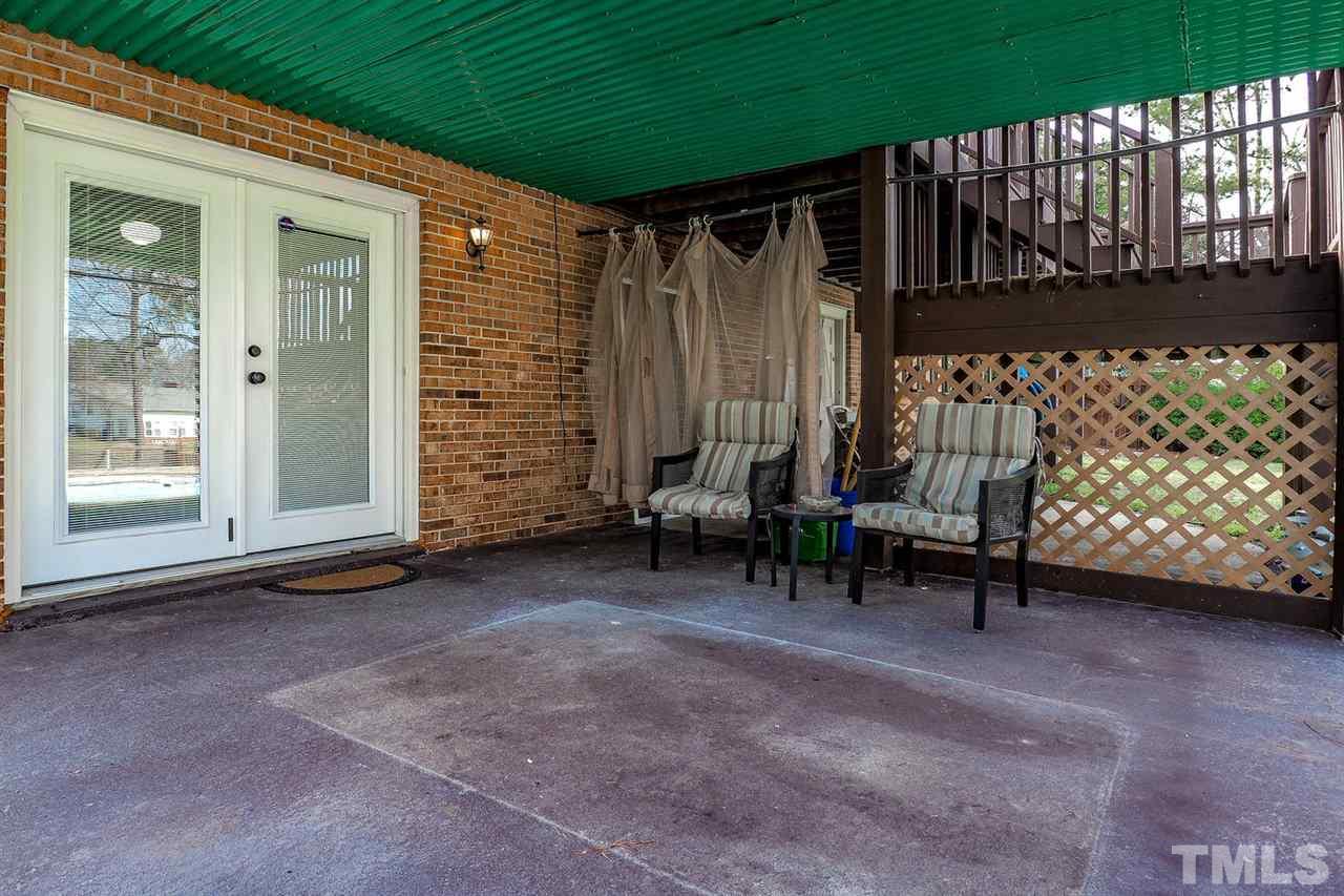 3953 Haithcock Road Raleigh, NC 27604 - Photo 22 of 25 a view of an chairs with porch in the backyard