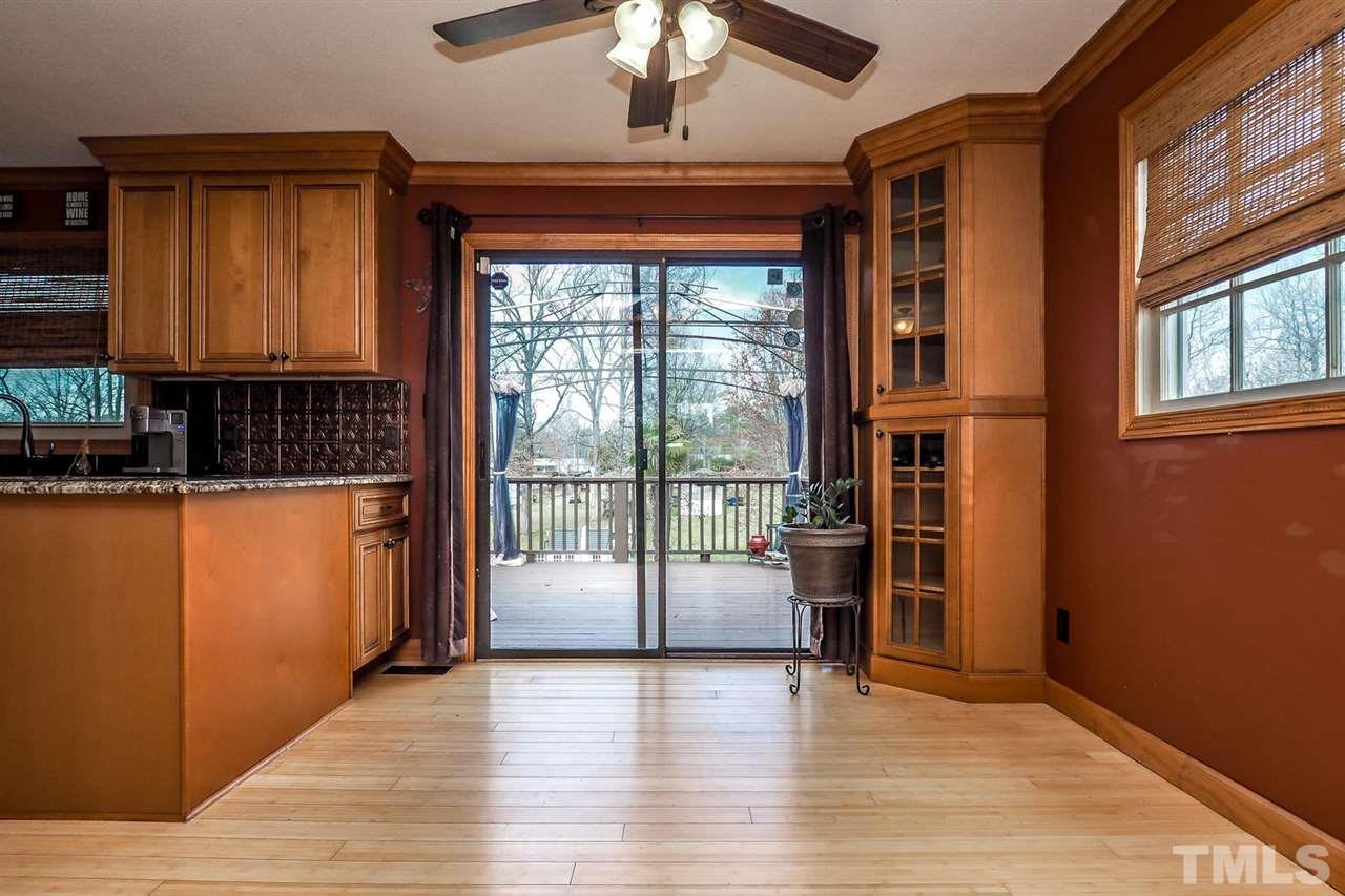 3953 Haithcock Road Raleigh, NC 27604 - Photo 6 of 25 a view of empty room with wooden floor and fan