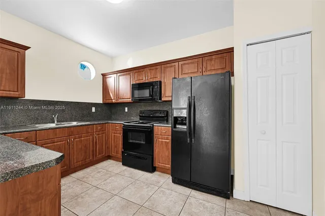 a kitchen with granite countertop a sink and a stove