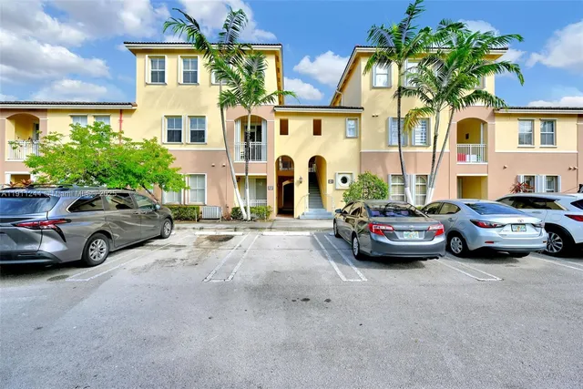 a view of cars parked in front of a house