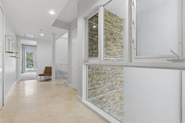 an empty room with a ceiling fan and a window