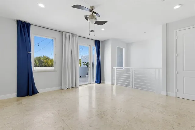 a view of a big room with closet and windows