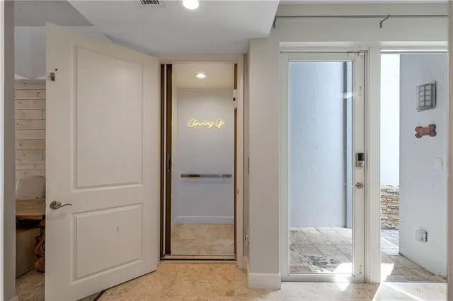 a view of a hallway with wooden floor and entryway