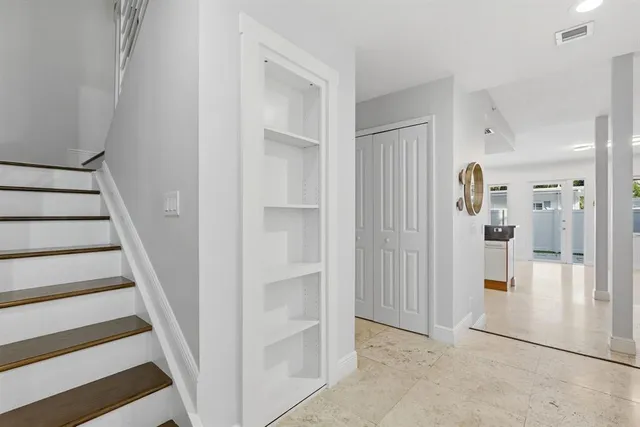 a view of a kitchen with granite countertop a sink and cabinets