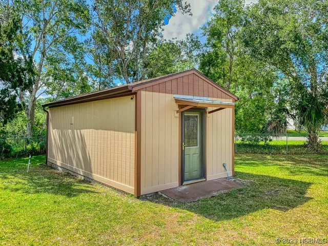 a street view of a brick wall with a swimming pool