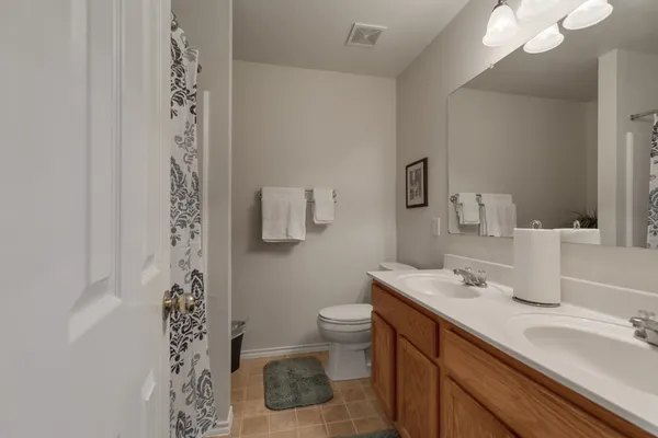 a bathroom with a sink a toilet and a mirror