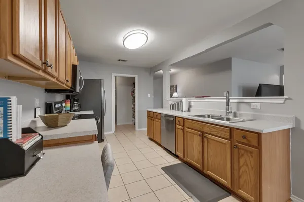 a large kitchen with kitchen island a sink stainless steel appliances and cabinets