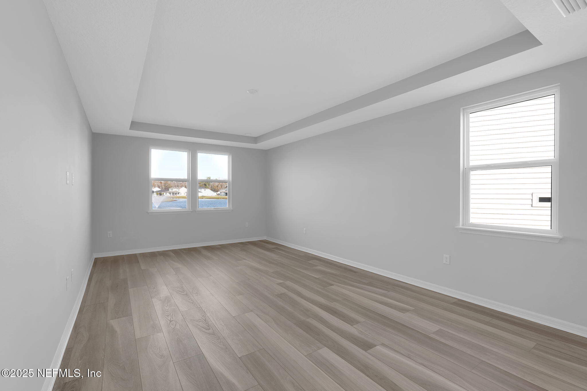 133 Beechnut Circle St. Augustine, FL 32095 - Photo 20 of 53 an empty room with wooden floor and windows