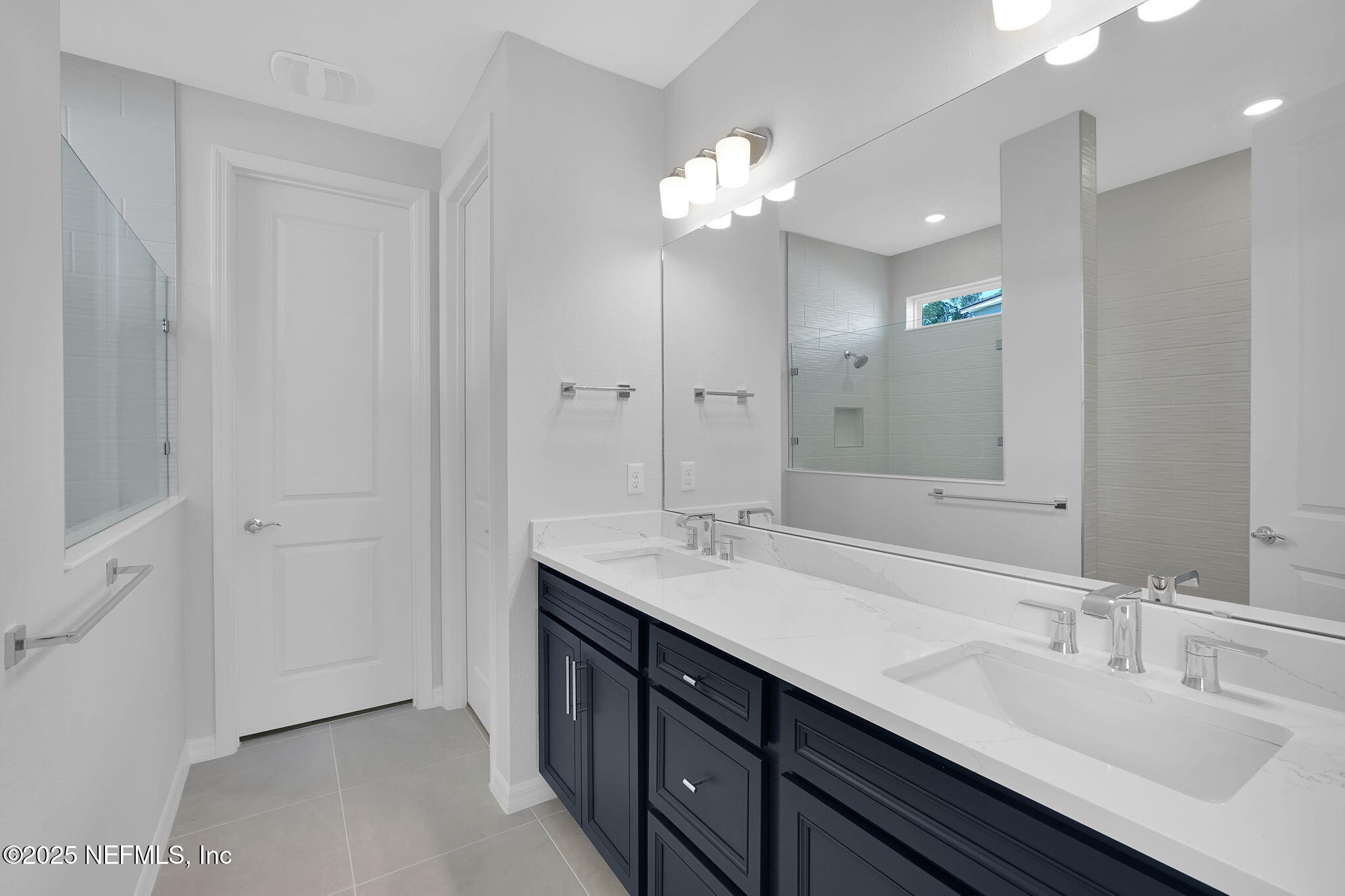 133 Beechnut Circle St. Augustine, FL 32095 - Photo 21 of 53 a bathroom with a double vanity sink and a mirror