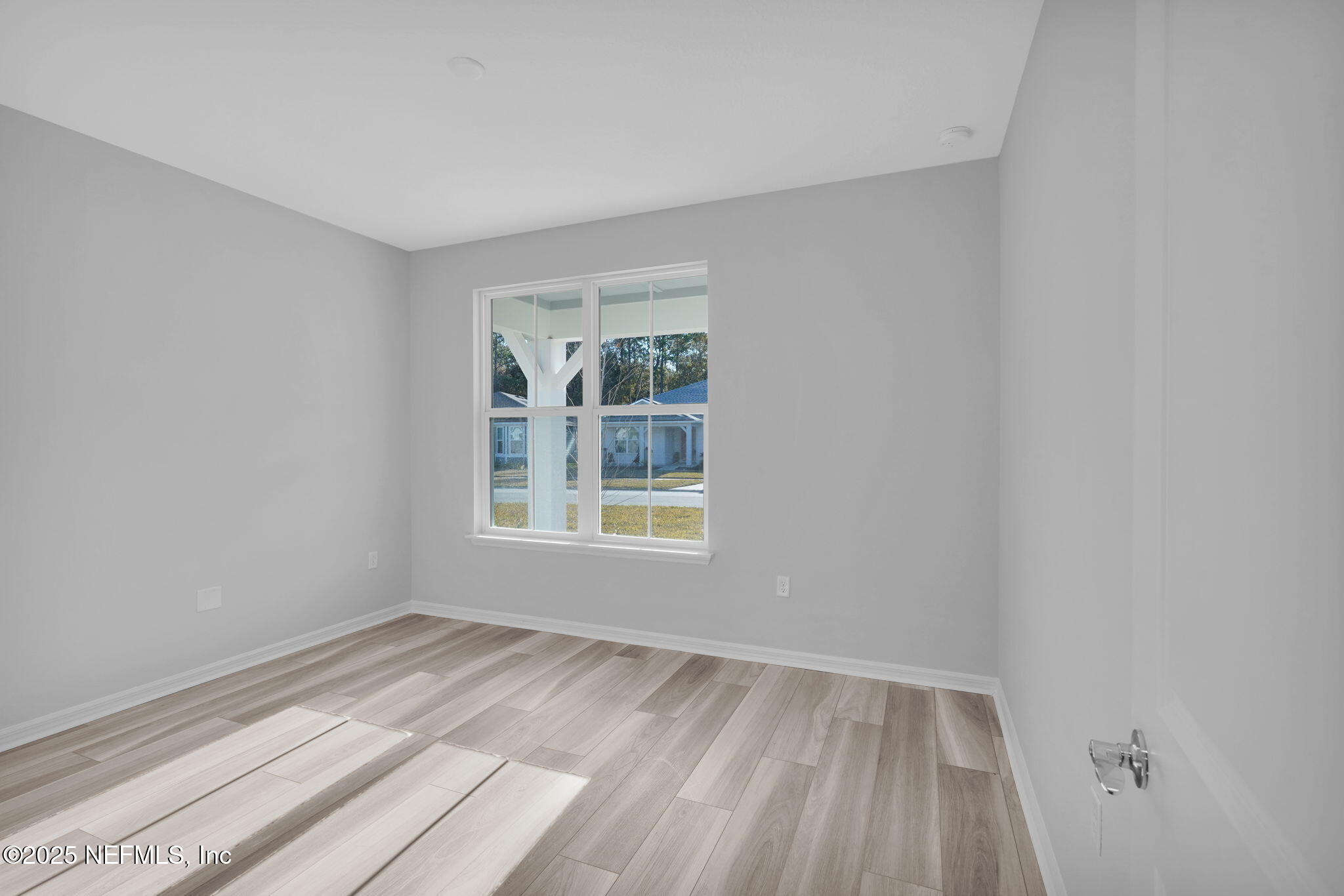 133 Beechnut Circle St. Augustine, FL 32095 - Photo 30 of 53 an empty room with wooden floor and windows