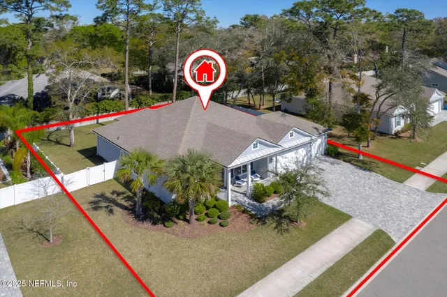 an aerial view of residential house with an outdoor space and seating