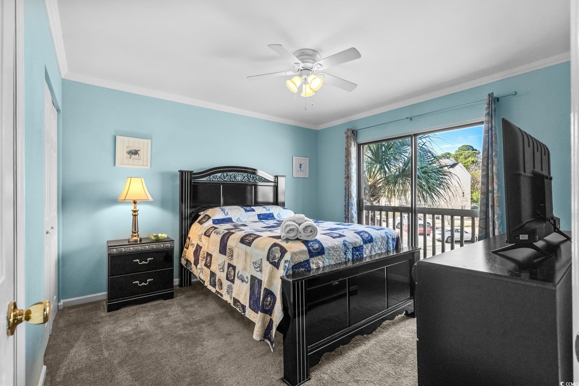 1356 Glenns Bay Road, Unit 203D Surfside Beach, SC 29575 - Photo 12 of 38 Bedroom featuring ornamental molding, carpet floors, and a ceiling fan