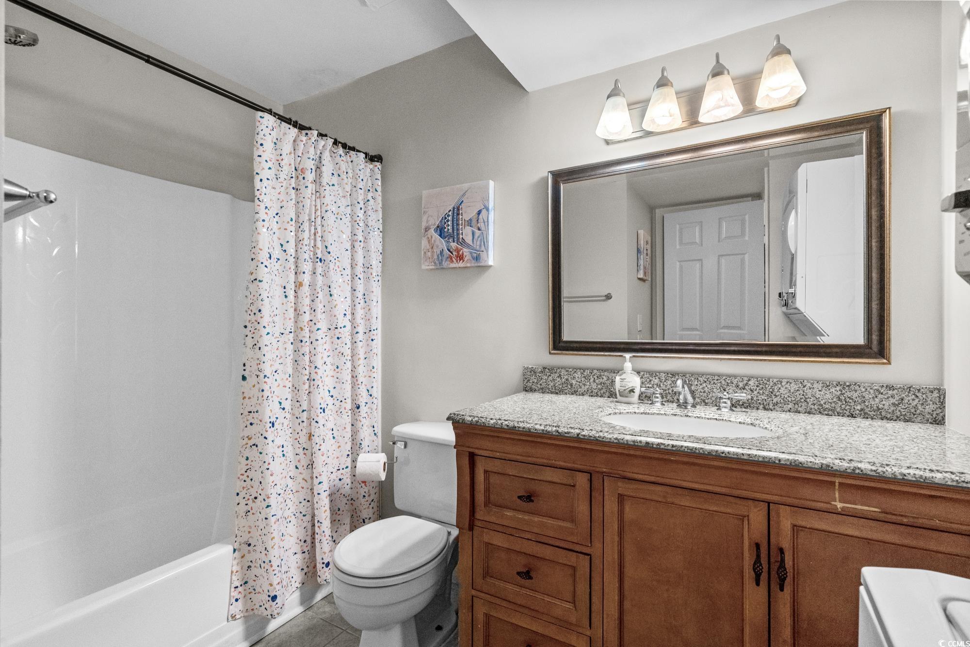1356 Glenns Bay Road, Unit 203D Surfside Beach, SC 29575 - Photo 15 of 38 Full bathroom featuring shower / tub combo with curtain, vanity, and light tile patterned floors