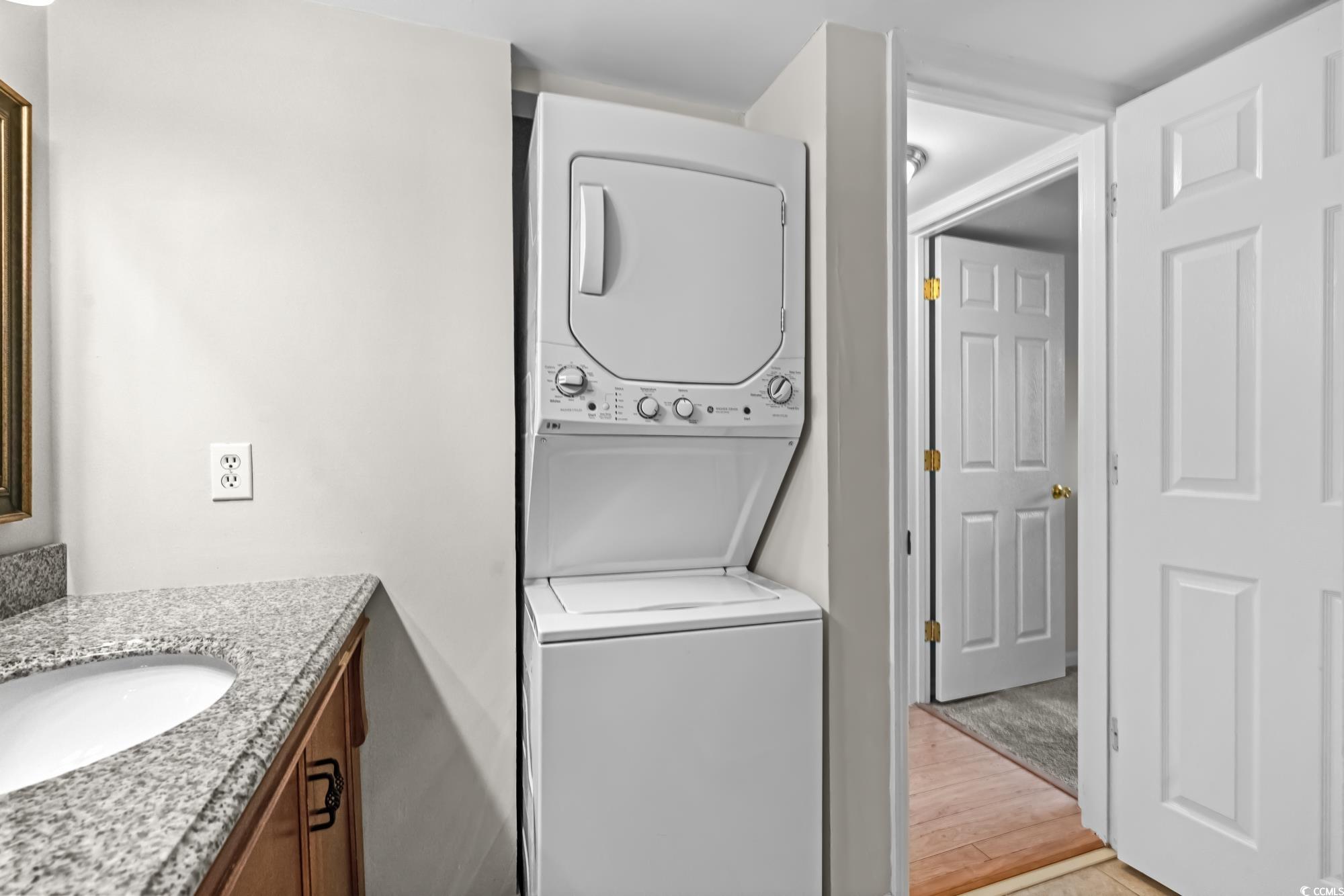 1356 Glenns Bay Road, Unit 203D Surfside Beach, SC 29575 - Photo 16 of 38 Laundry area featuring stacked washer / drying machine and light wood finished floors