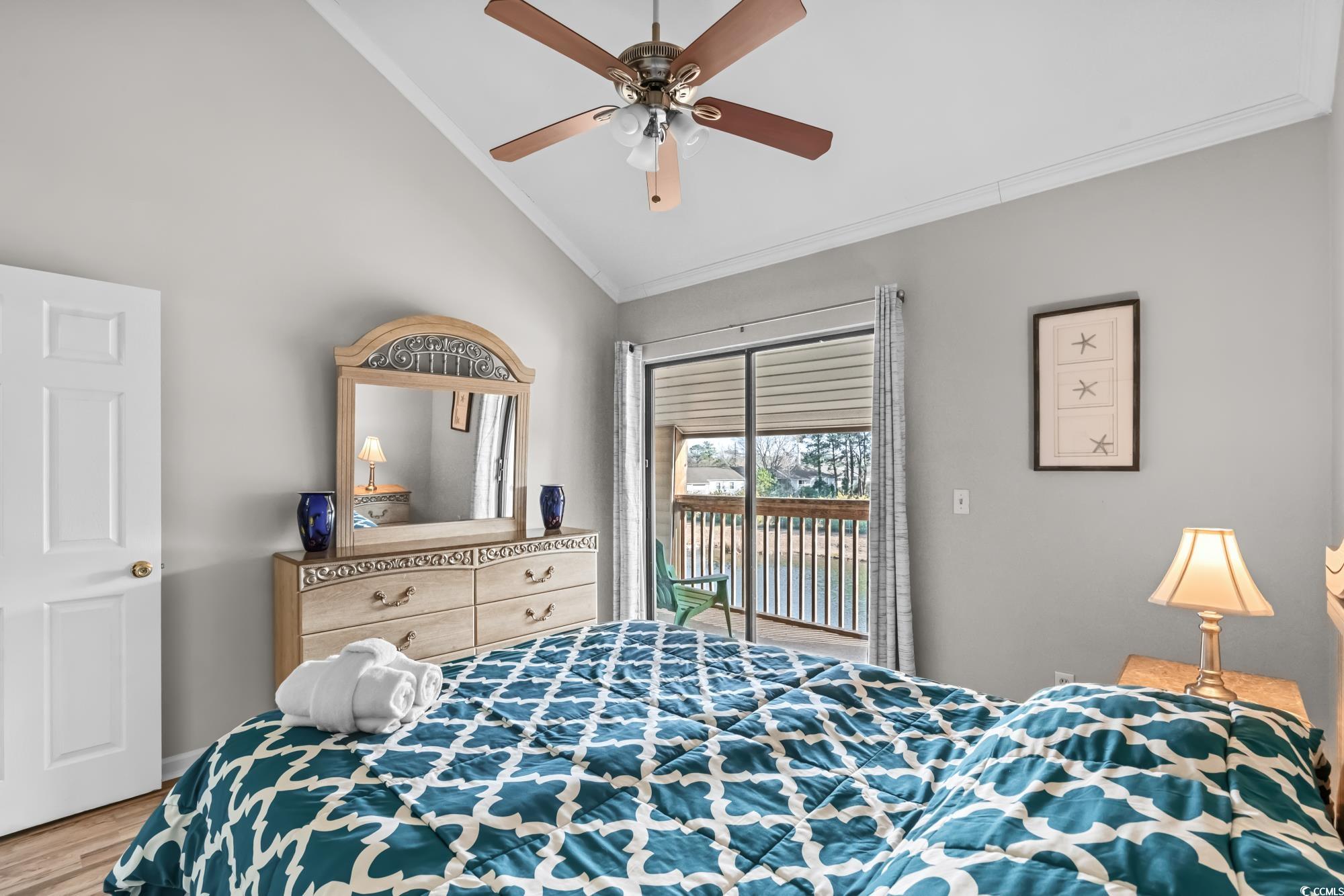 1356 Glenns Bay Road, Unit 203D Surfside Beach, SC 29575 - Photo 18 of 38 Bedroom with access to outside, wood finished floors, ornamental molding, a ceiling fan, and high vaulted ceiling