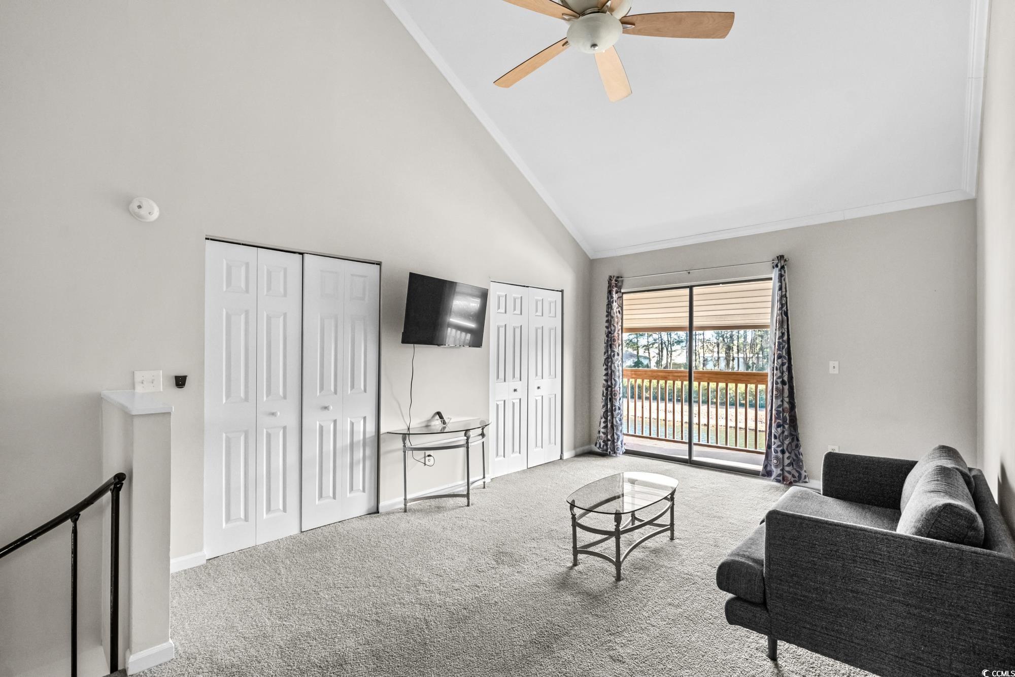 1356 Glenns Bay Road, Unit 203D Surfside Beach, SC 29575 - Photo 19 of 38 Living area with high vaulted ceiling, carpet floors, and ceiling fan