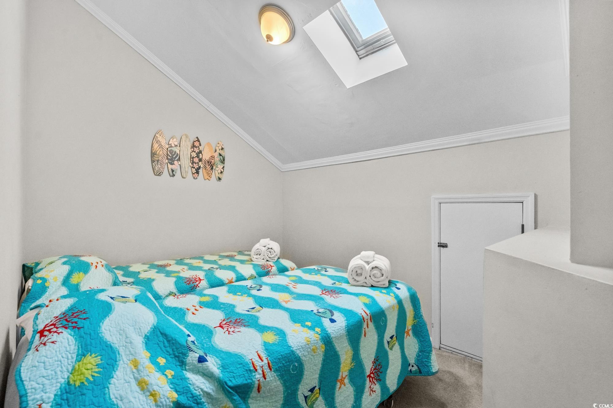 1356 Glenns Bay Road, Unit 203D Surfside Beach, SC 29575 - Photo 22 of 38 Bedroom featuring a skylight, carpet floors, lofted ceiling, and crown molding