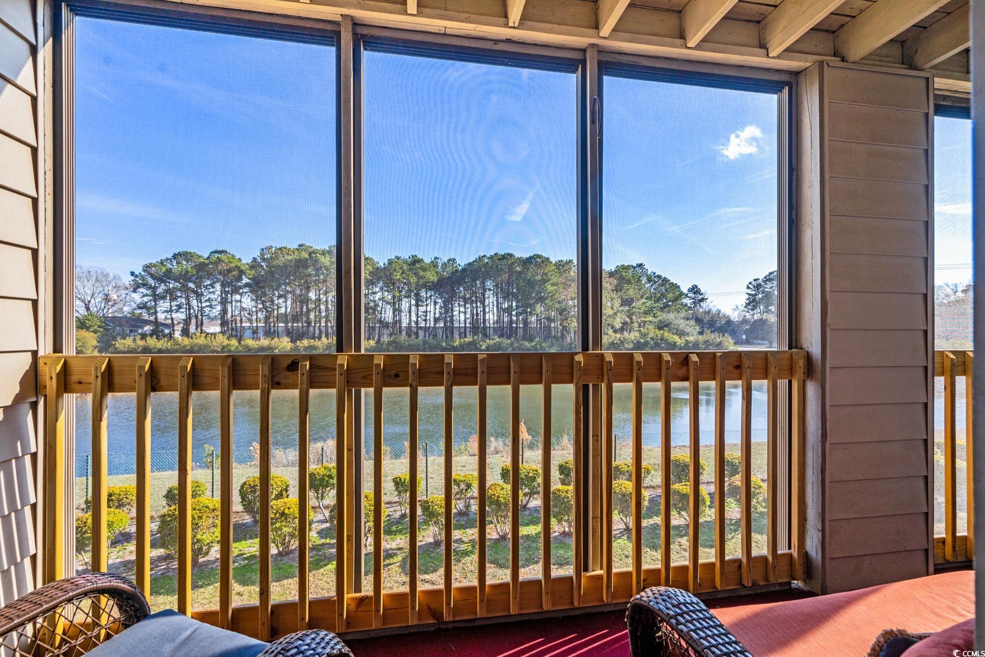 1356 Glenns Bay Road, Unit 203D Surfside Beach, SC 29575 - Photo 23 of 38 Sunroom / solarium with a water view and view of scattered trees