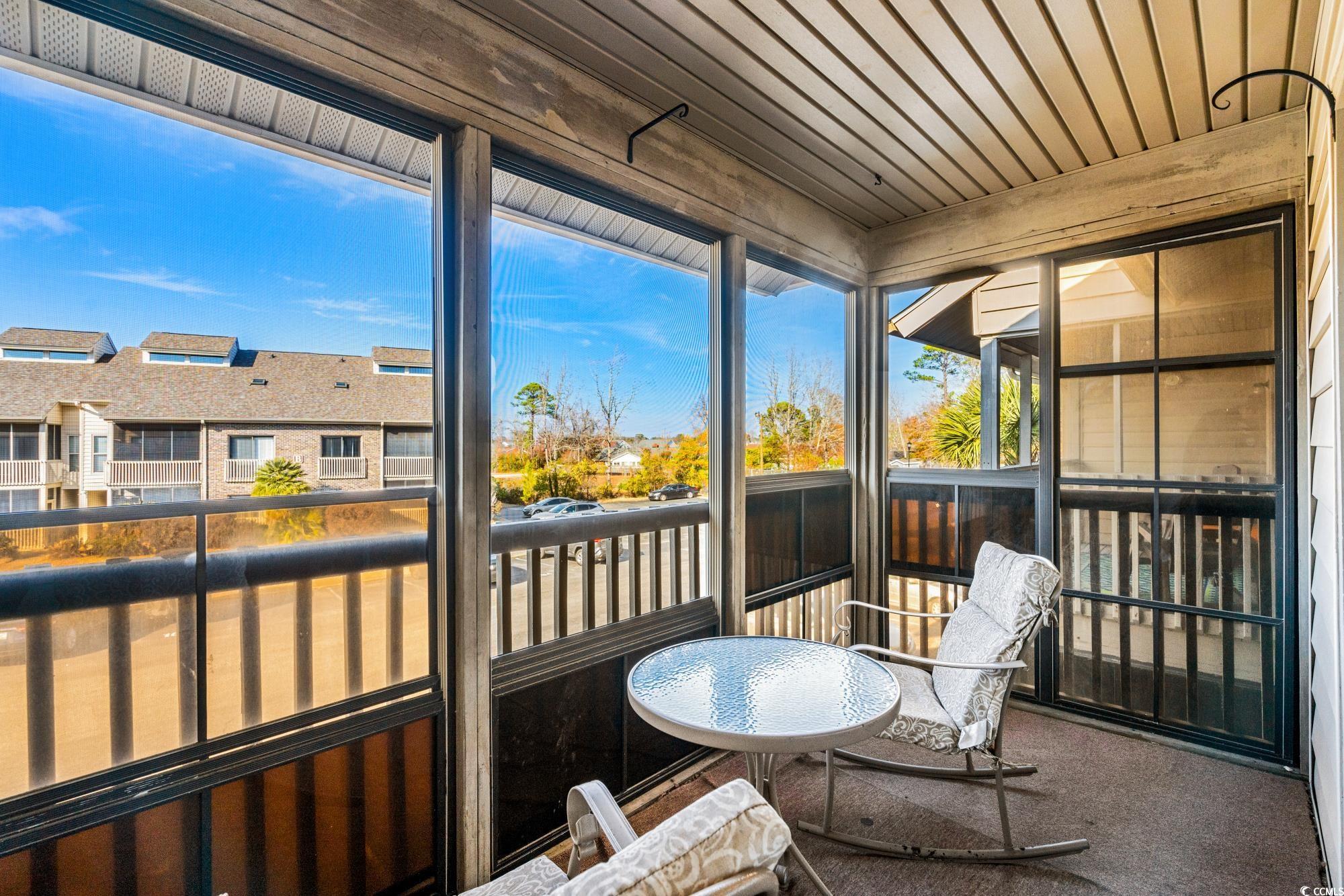 1356 Glenns Bay Road, Unit 203D Surfside Beach, SC 29575 - Photo 25 of 38 Sunroom / solarium with a balcony