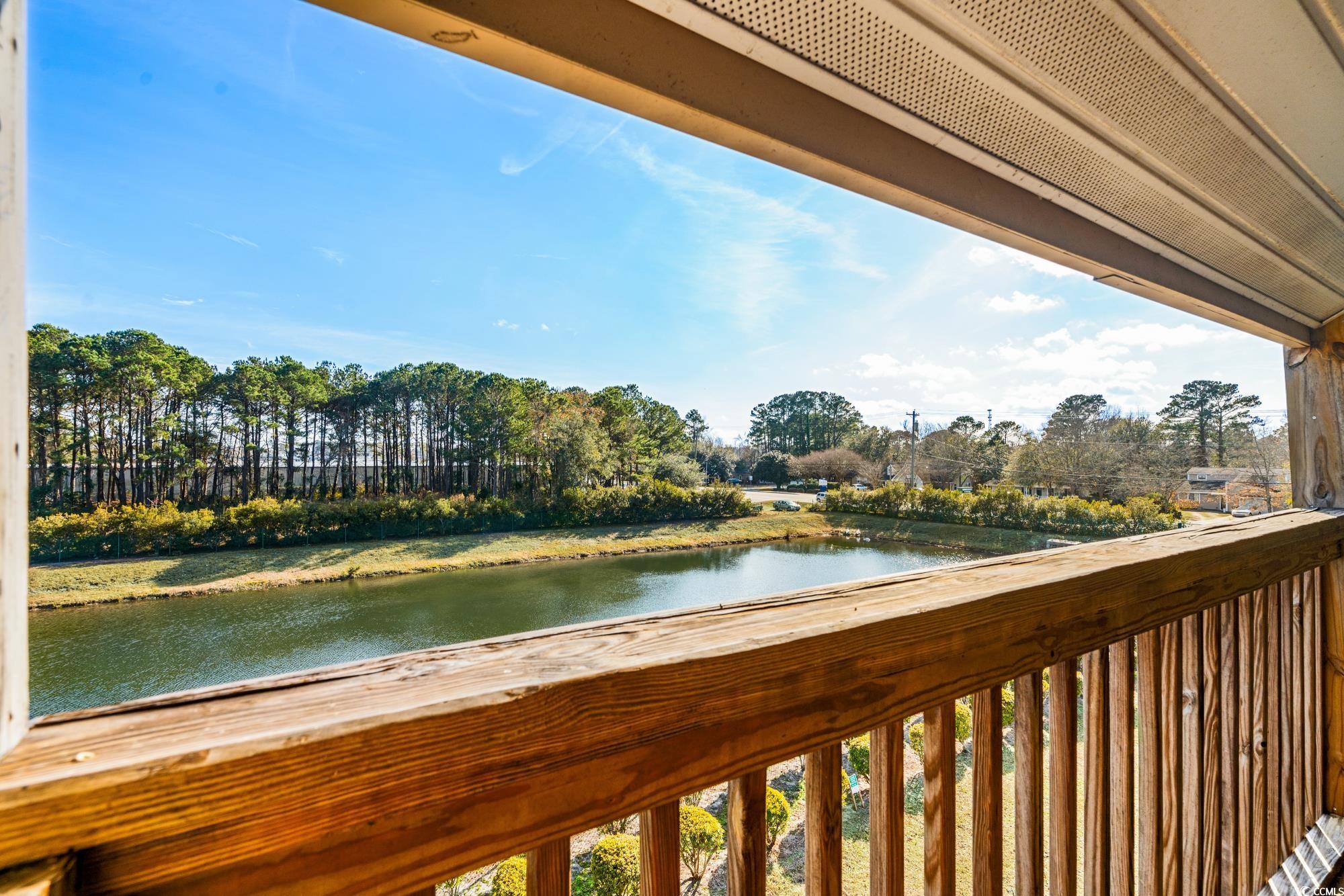 1356 Glenns Bay Road, Unit 203D Surfside Beach, SC 29575 - Photo 27 of 38 Balcony with a water view and view of scattered trees