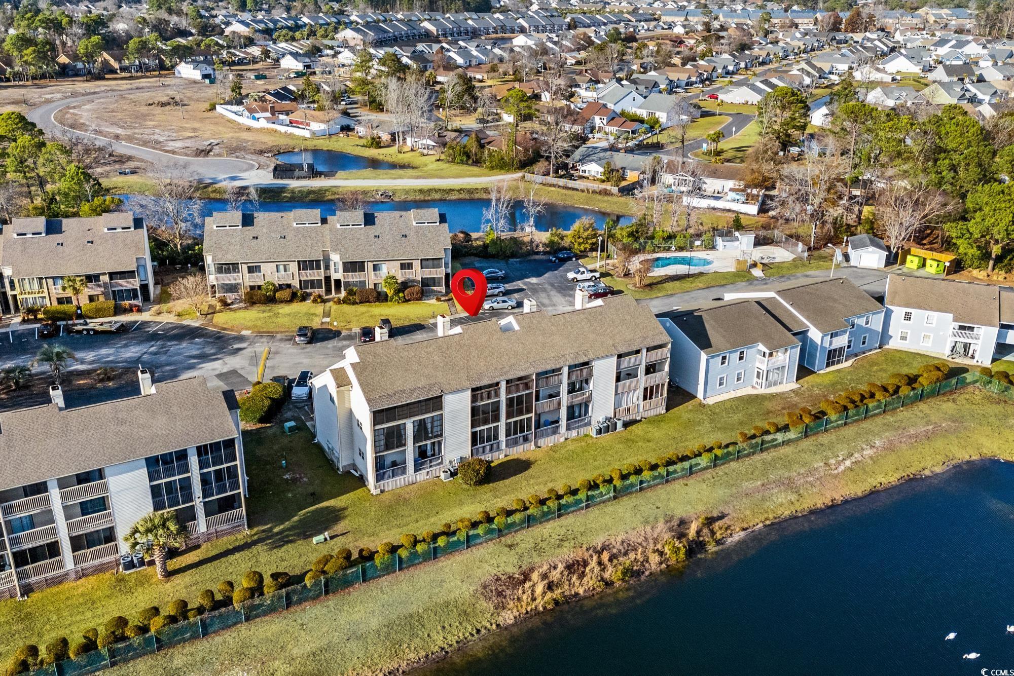 1356 Glenns Bay Road, Unit 203D Surfside Beach, SC 29575 - Photo 30 of 38 Aerial view of property and surrounding area featuring a large body of water and nearby suburban area