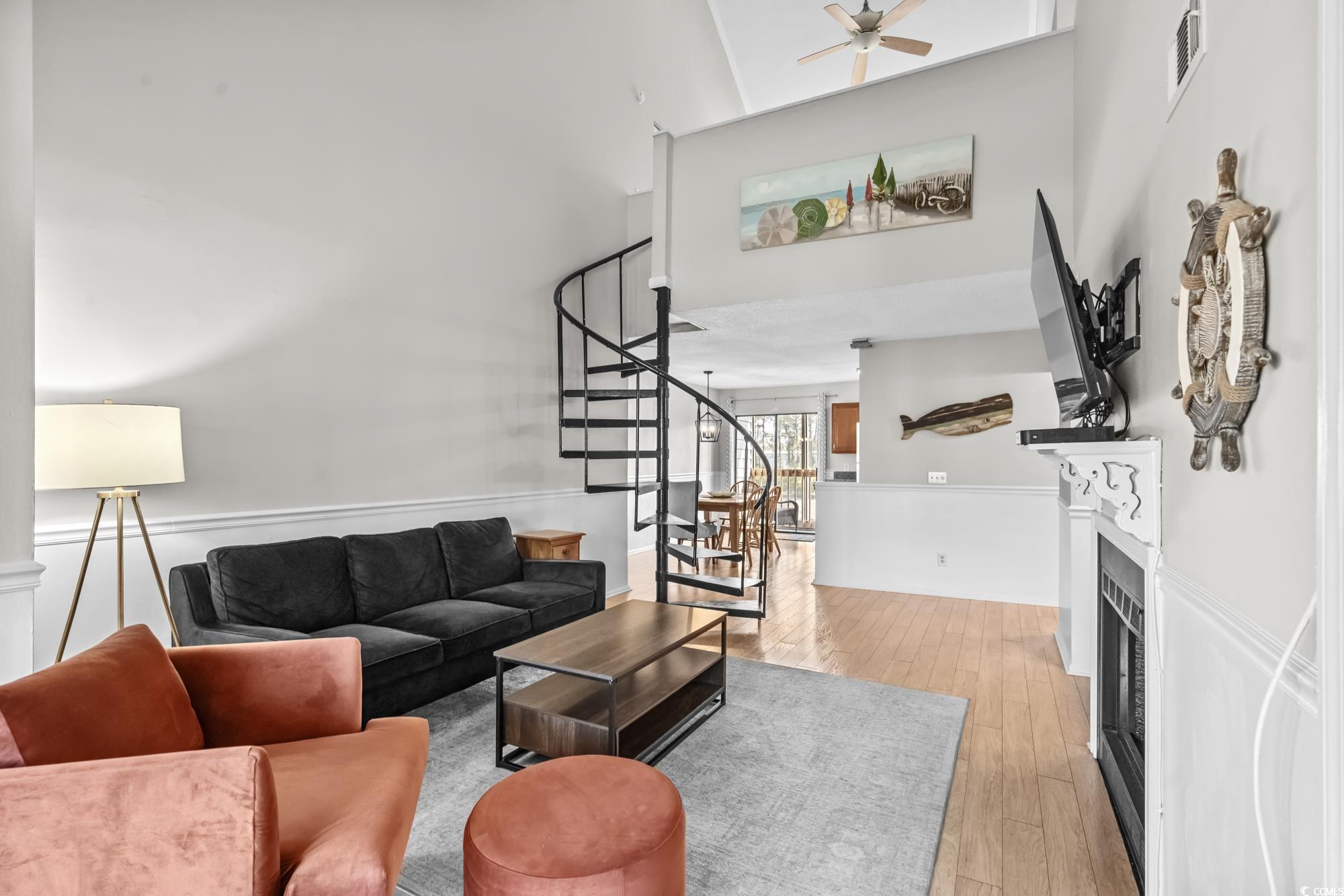 1356 Glenns Bay Road, Unit 203D Surfside Beach, SC 29575 - Photo 3 of 38 Living room featuring a fireplace, a high ceiling, light wood-style floors, stairs, and ceiling fan