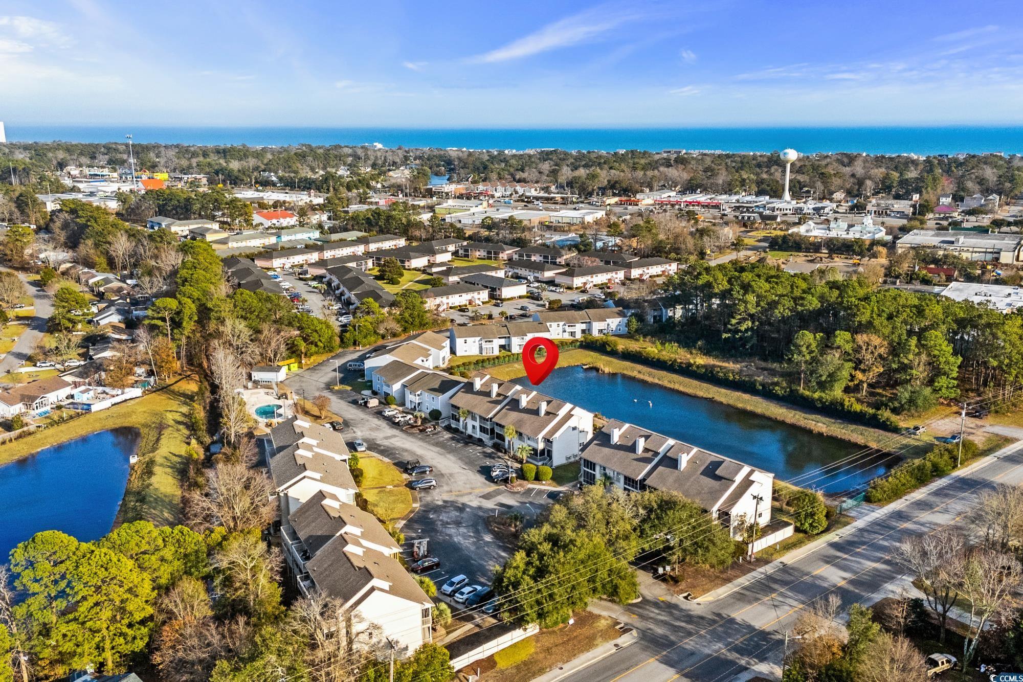 1356 Glenns Bay Road, Unit 203D Surfside Beach, SC 29575 - Photo 31 of 38 Aerial view of residential area featuring a nearby body of water and a tree filled landscape