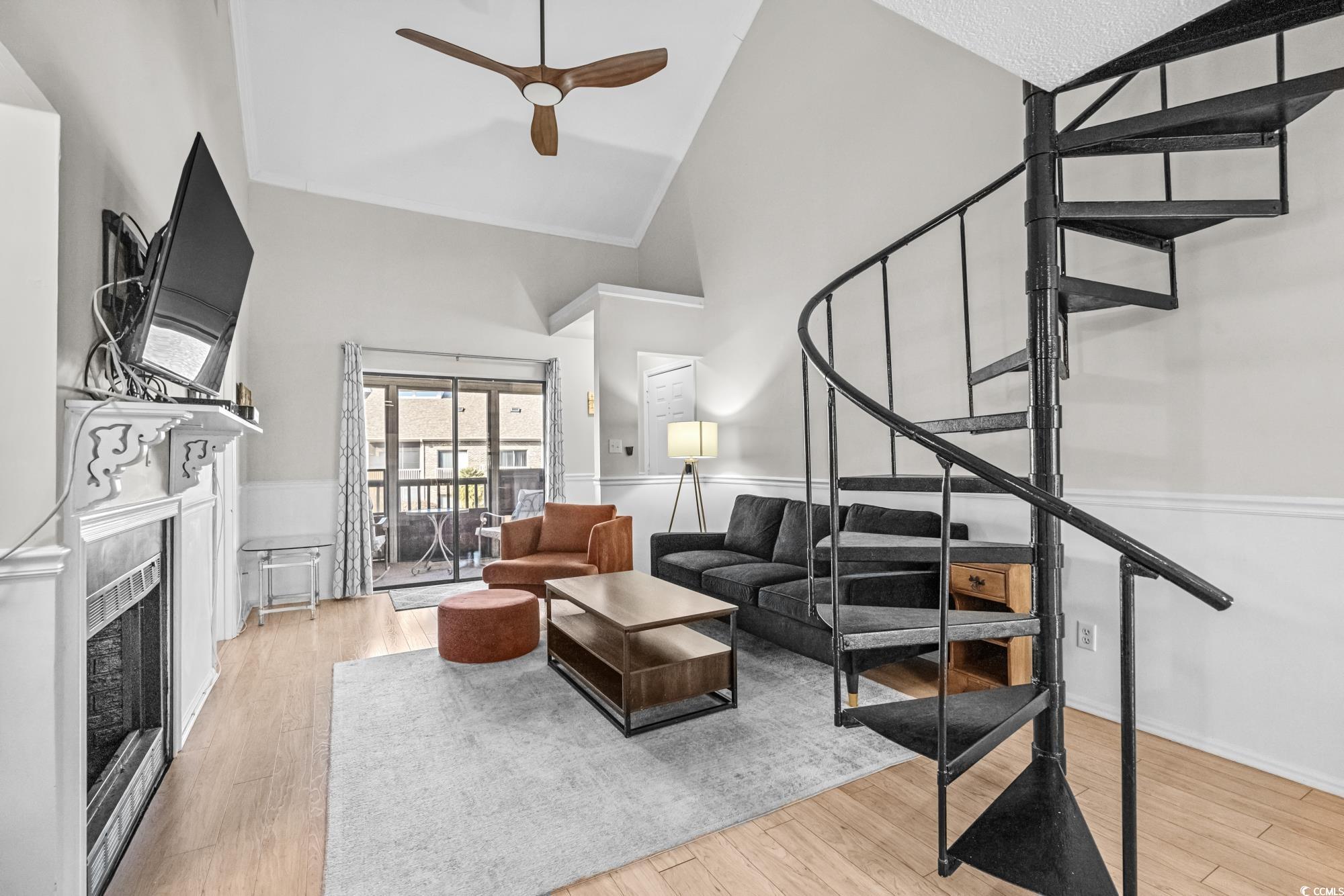 1356 Glenns Bay Road, Unit 203D Surfside Beach, SC 29575 - Photo 6 of 38 Living room with high vaulted ceiling, stairway, light wood finished floors, a fireplace, and a ceiling fan