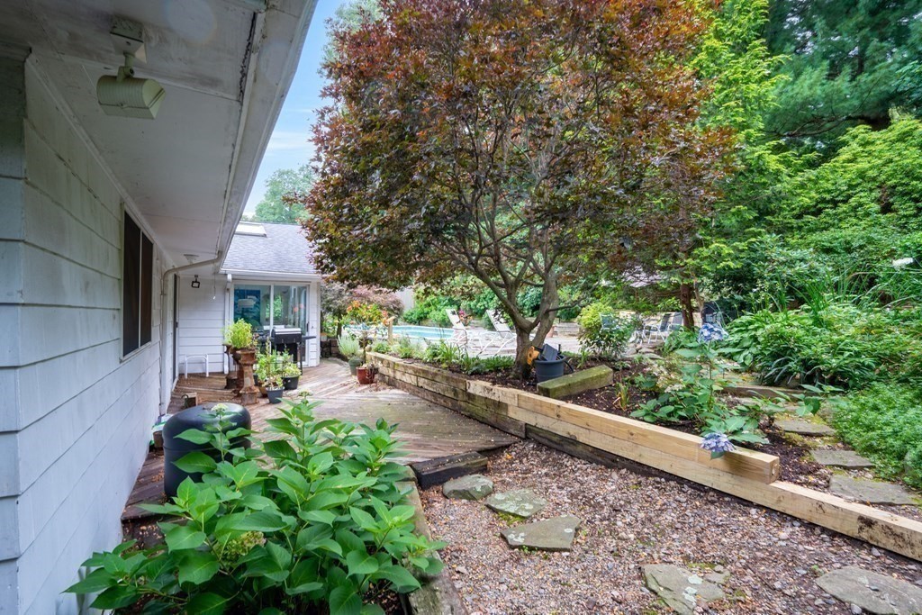 33 Sky View Circle Newton, MA 02459 - Photo 22 of 42 a view of a patio with table and chairs potted plants and large tree