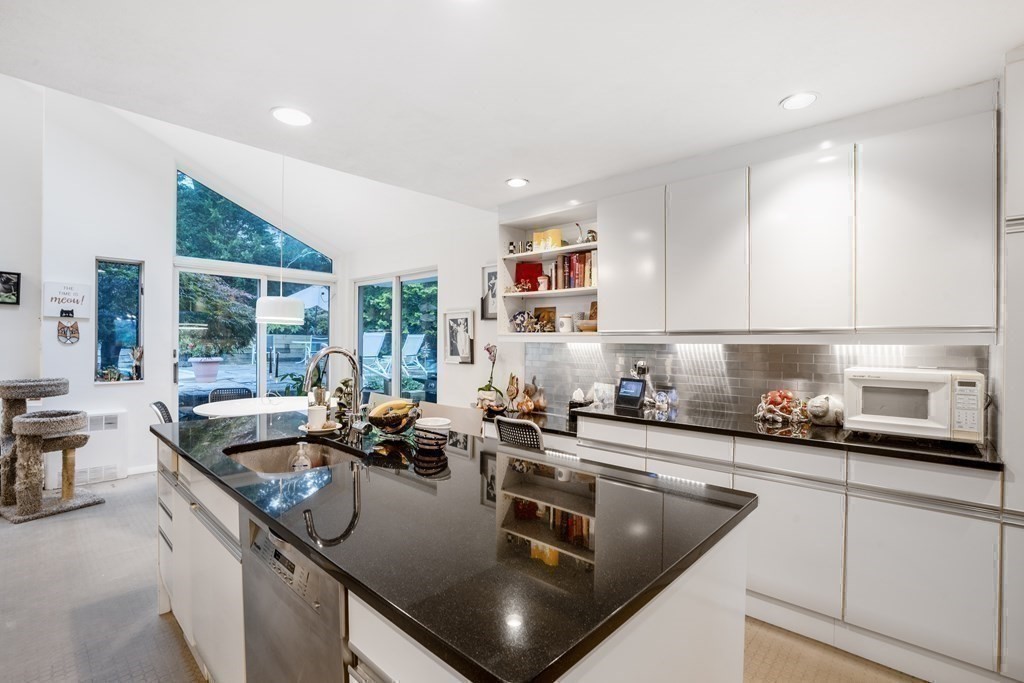33 Sky View Circle Newton, MA 02459 - Photo 25 of 42 a kitchen with stainless steel appliances granite countertop a sink a stove and a wooden cabinets
