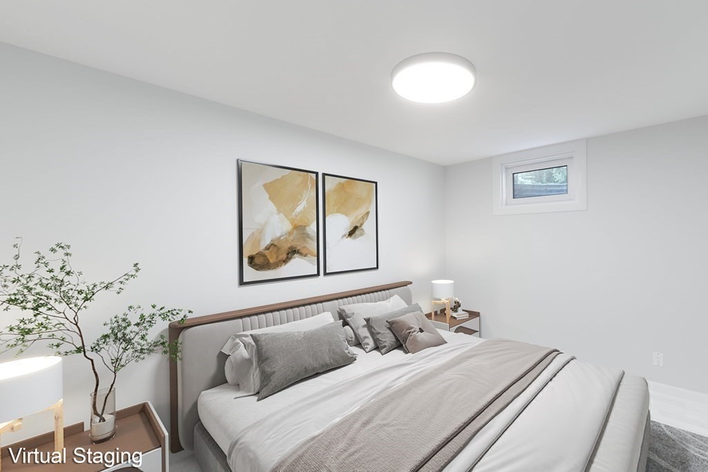 33 Sky View Circle Newton, MA 02459 - Photo 33 of 42 a bedroom with a bed and a painting on the wall