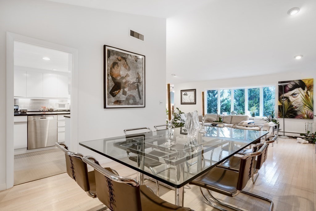 33 Sky View Circle Newton, MA 02459 - Photo 4 of 42 a kitchen with stainless steel appliances granite countertop a stove top oven a sink a dining table and chairs