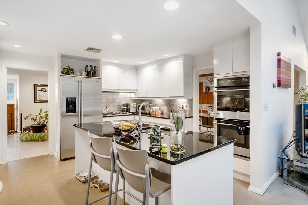 33 Sky View Circle Newton, MA 02459 - Photo 6 of 42 a kitchen with stainless steel appliances a stove a sink and a refrigerator