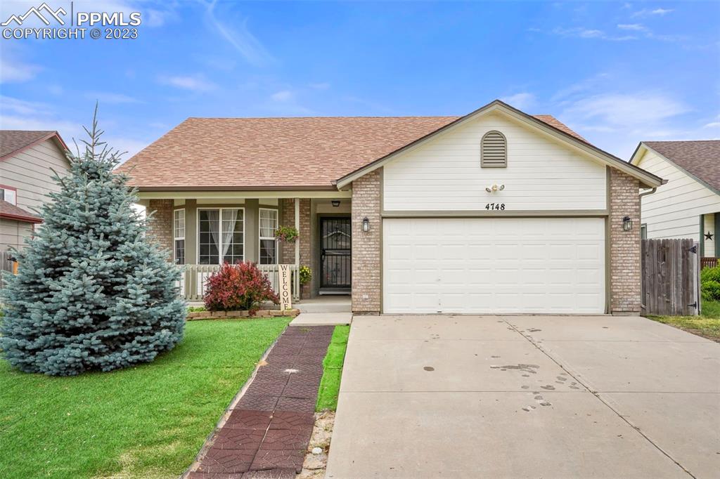 a front view of house with yard and green space