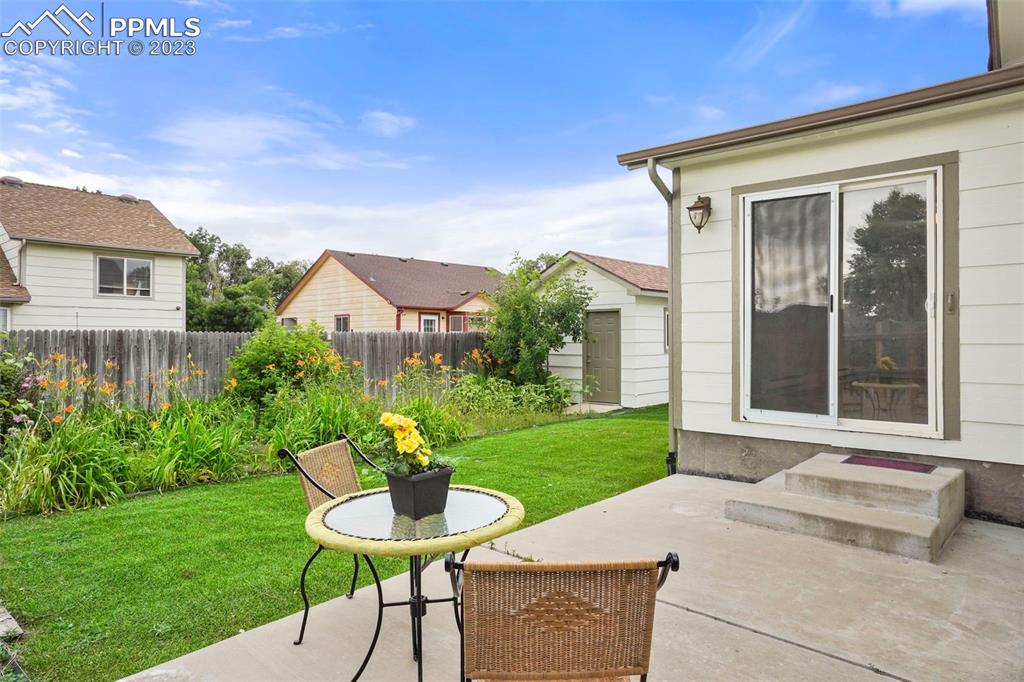 4748 Brant Road Colorado Springs, CO 80911 - Photo 17 of 19 a view of a chair and table in backyard of the house