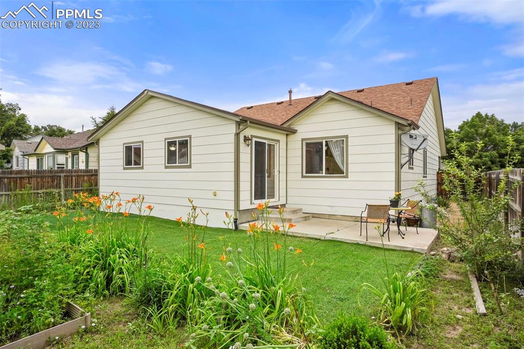 4748 Brant Road Colorado Springs, CO 80911 - Photo 19 of 19 a view of a house with a yard and sitting area