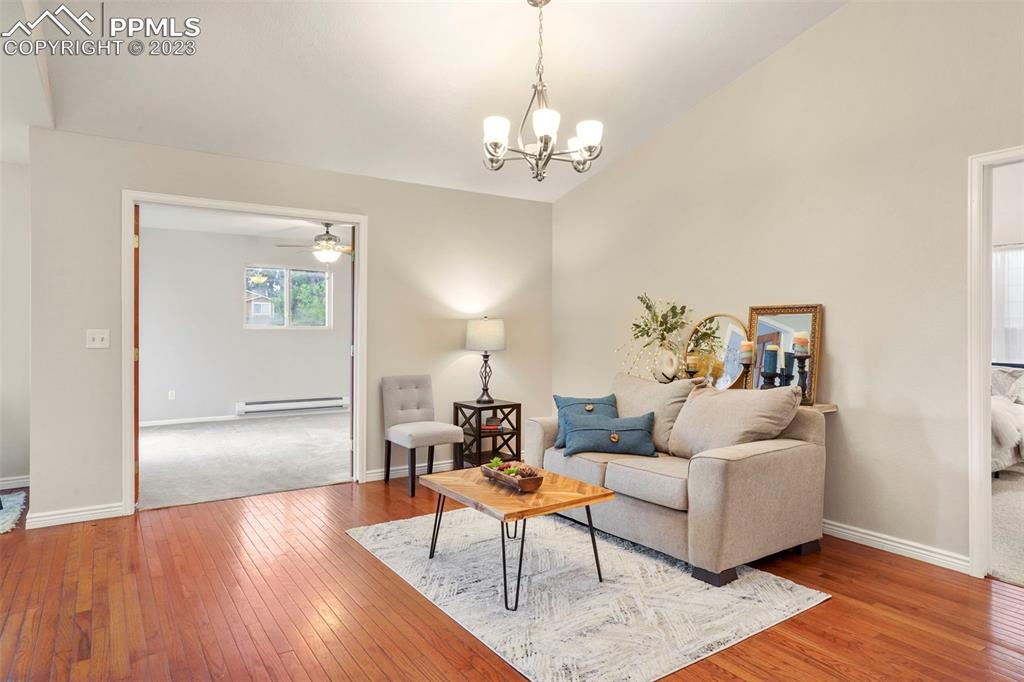 4748 Brant Road Colorado Springs, CO 80911 - Photo 2 of 19 a living room with furniture and a chandelier