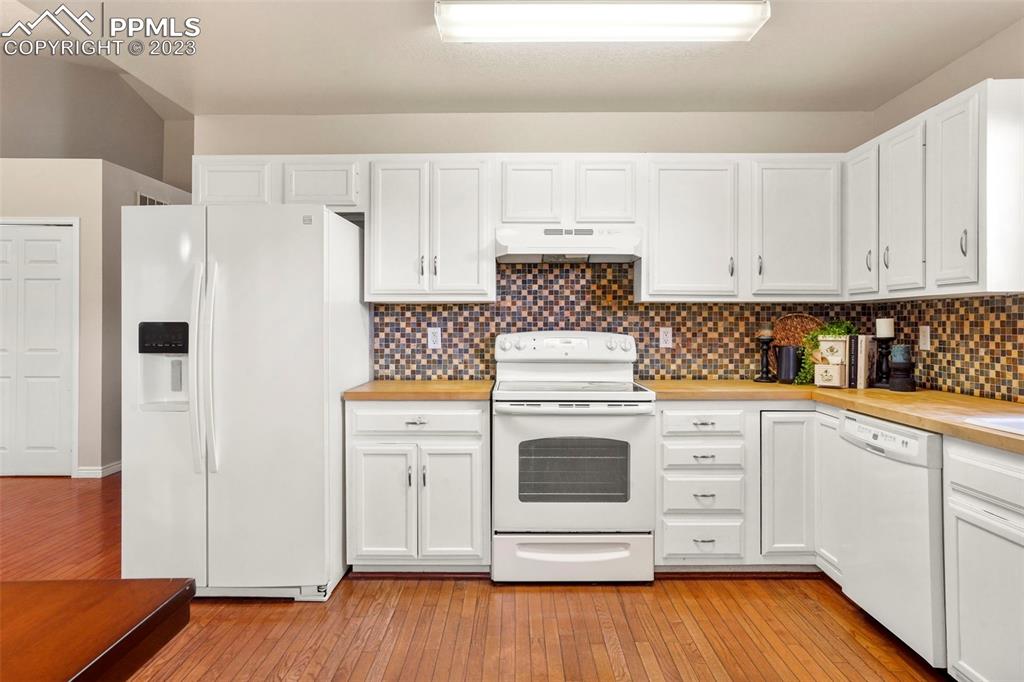 4748 Brant Road Colorado Springs, CO 80911 - Photo 5 of 19 a kitchen with stainless steel appliances white cabinets and a refrigerator