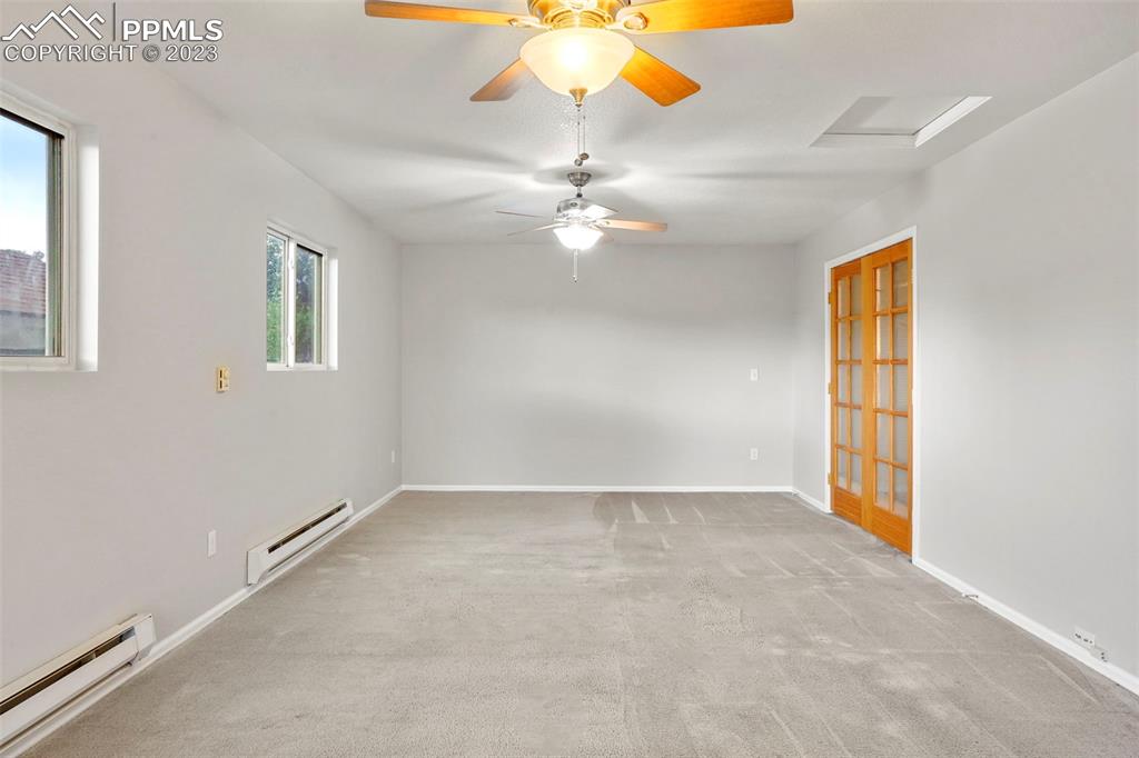 4748 Brant Road Colorado Springs, CO 80911 - Photo 7 of 19 an empty room with windows and fan